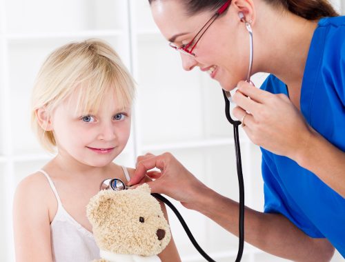 doctor examining little girl